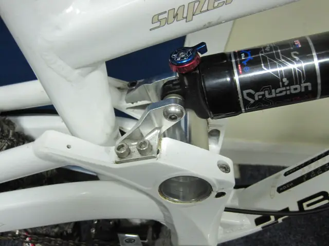 By moving the position of the rear shock swingarm mount (silver) you can change the BB height and geometry parameters.