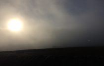 Misty clouds sun breaking through