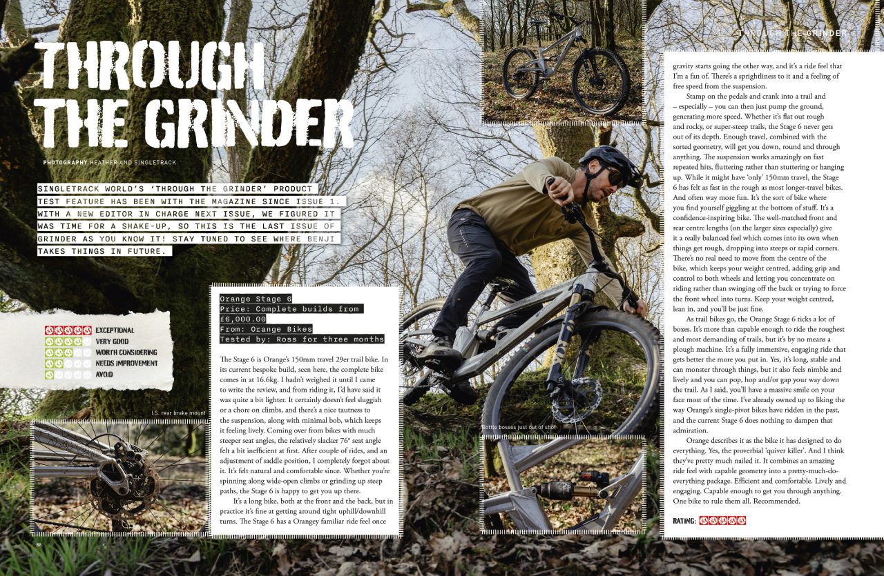 A mountain biker riding the Orange Stage 6 bike through a wooded area, demonstrating off-road cycling skills.