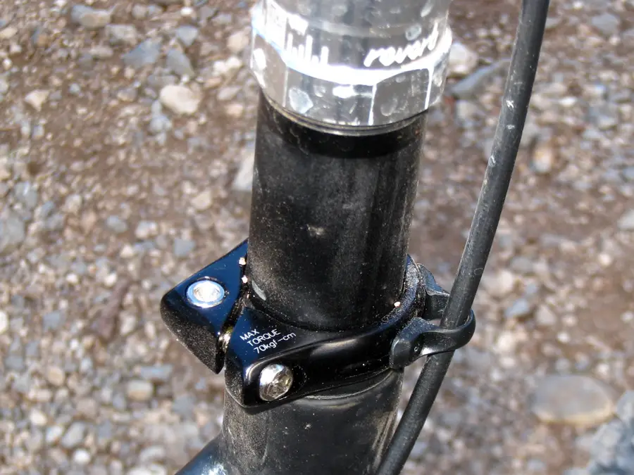 Holds seatpost, guides cable