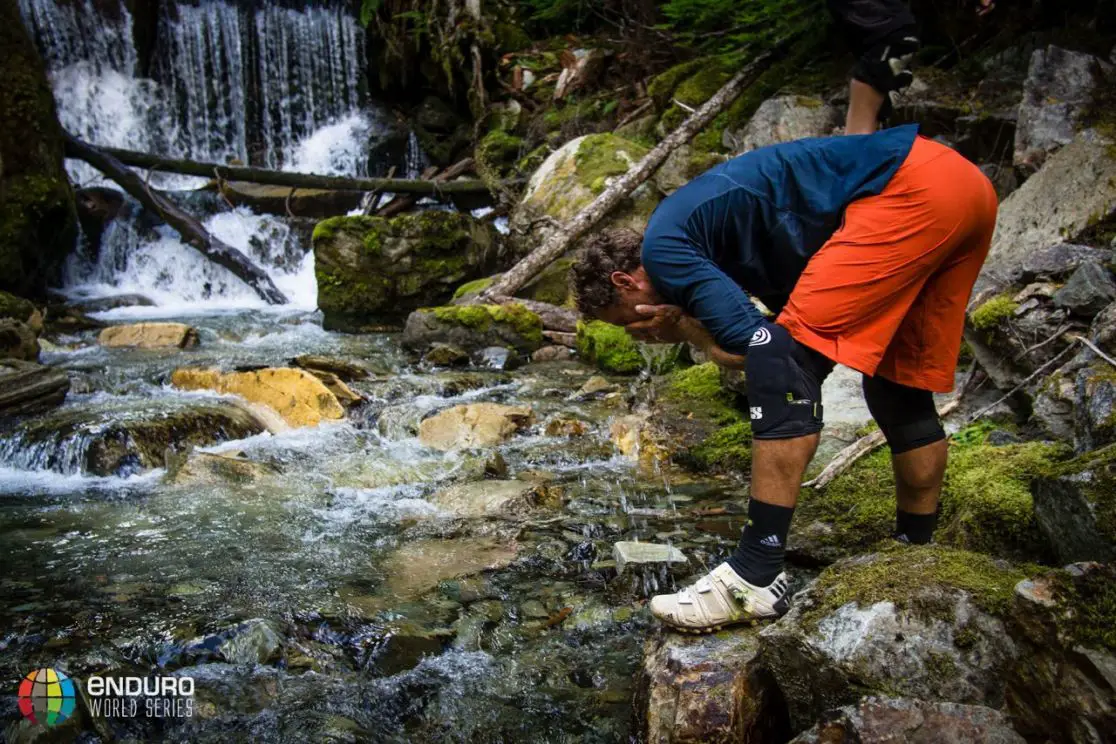 Issue 91 cover star Richie Schley freshens up on a rest stop on stage 4. EWS 6 2014 Whistler.