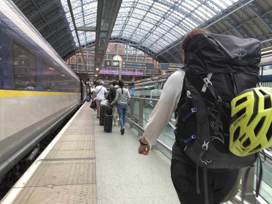 walking along a train platform with a rucksack