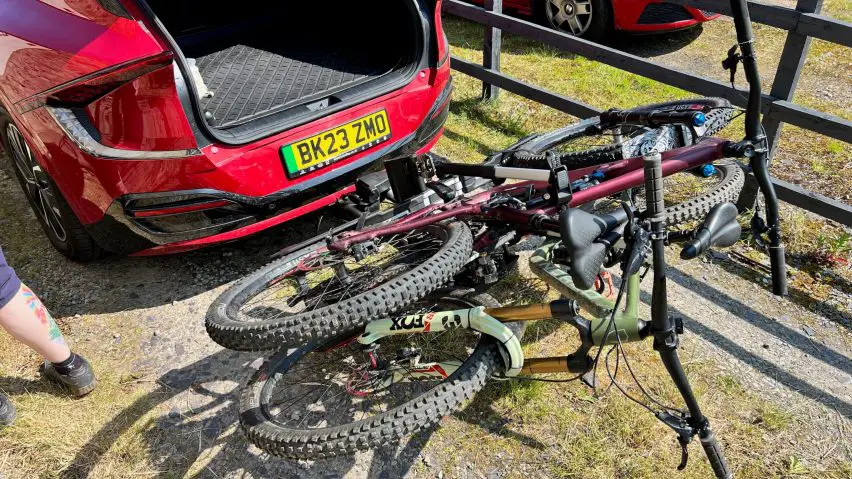 thule epos bike rack with two bikes attached tilted to allow boot access