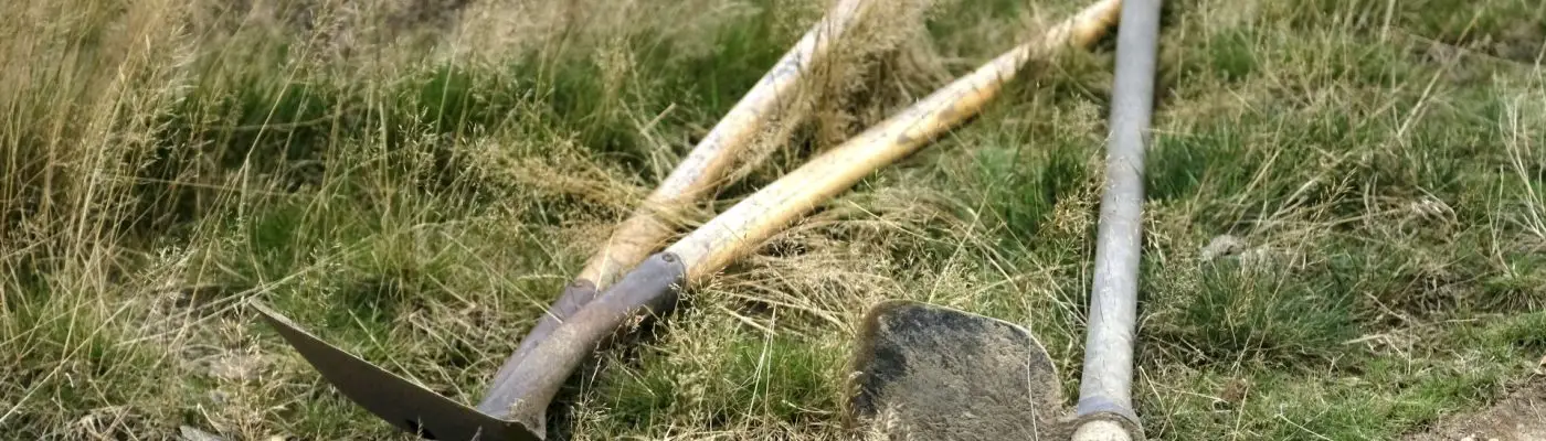 trail digging tools laid out on grass