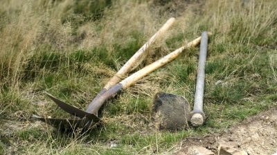 trail digging tools laid out on grass