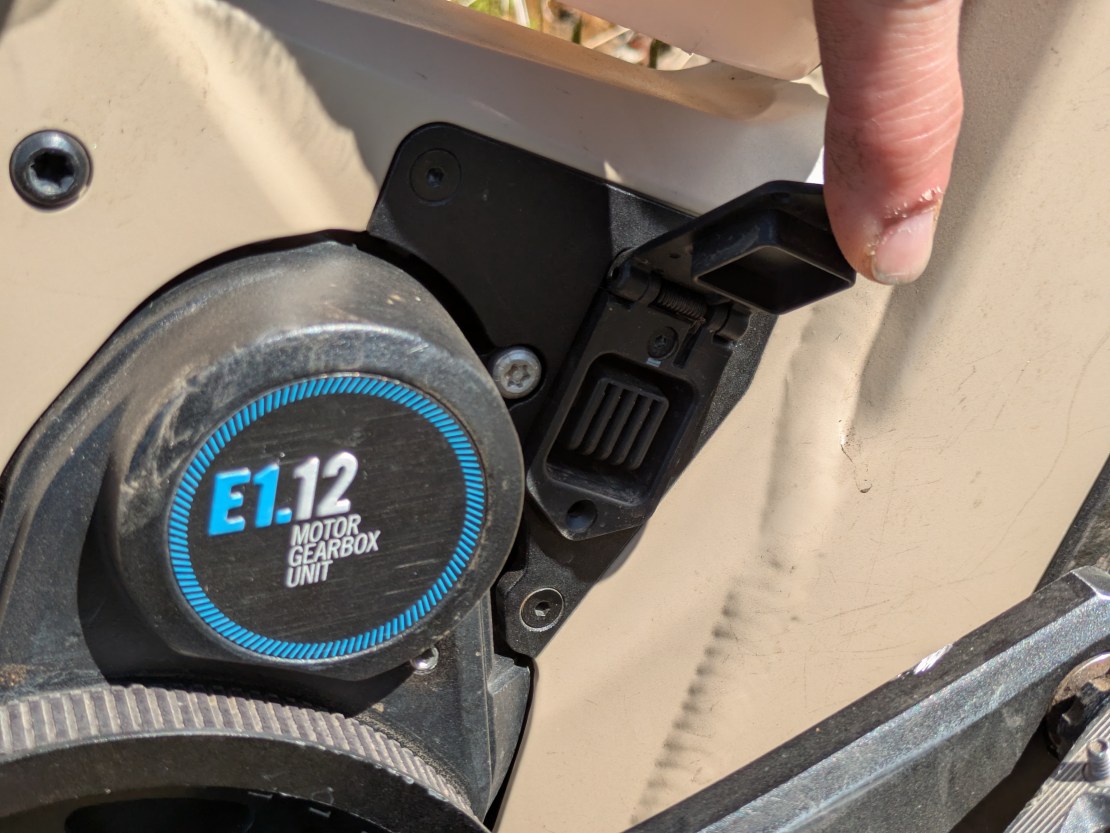 Close-up of the Moustache Clutch's Pinion MGU gearbox motor, showing the motor unit and a hand adjusting the setting.