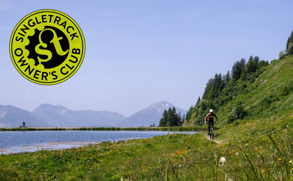 singletrack owners club round logo on image of riders in the french alps riding on singletrack with mountains in the background