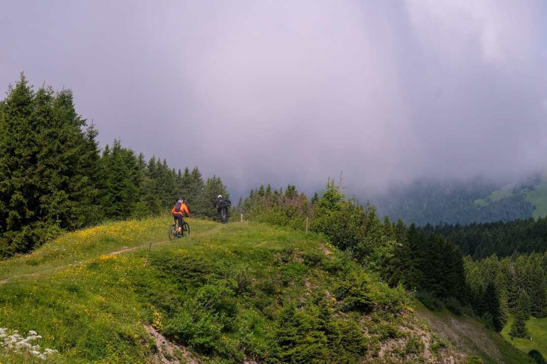 two mountain bikers on a ridge above the towns of Morzine and les gets in the french alps.