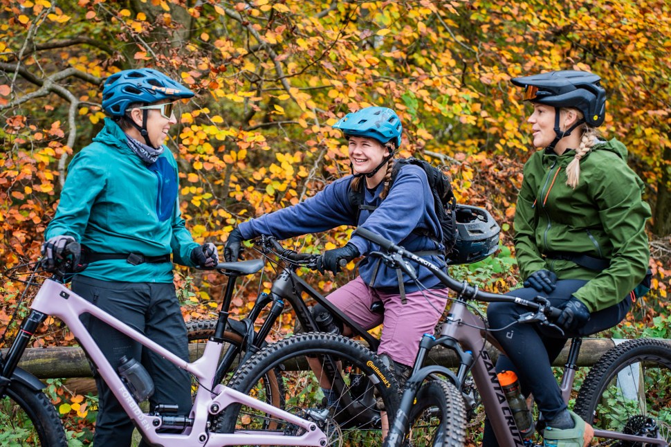 Three women are laughing together before an MTB ride