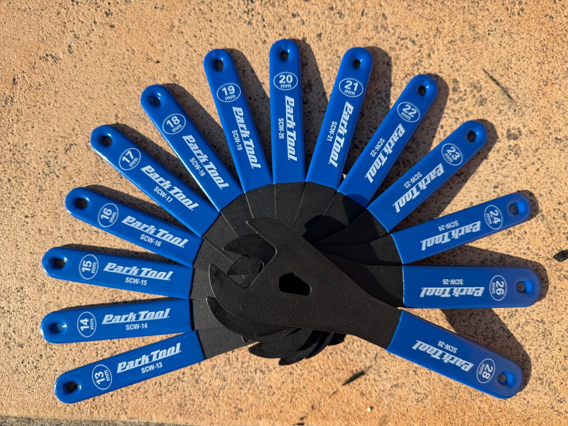 A set of Park Tool cone spanners in various sizes, displayed in a fan shape on a textured surface.