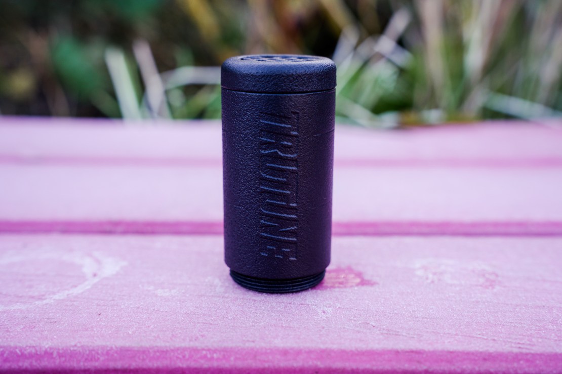 A close-up image of a black Trutune fork air insert on a wooden pink background.