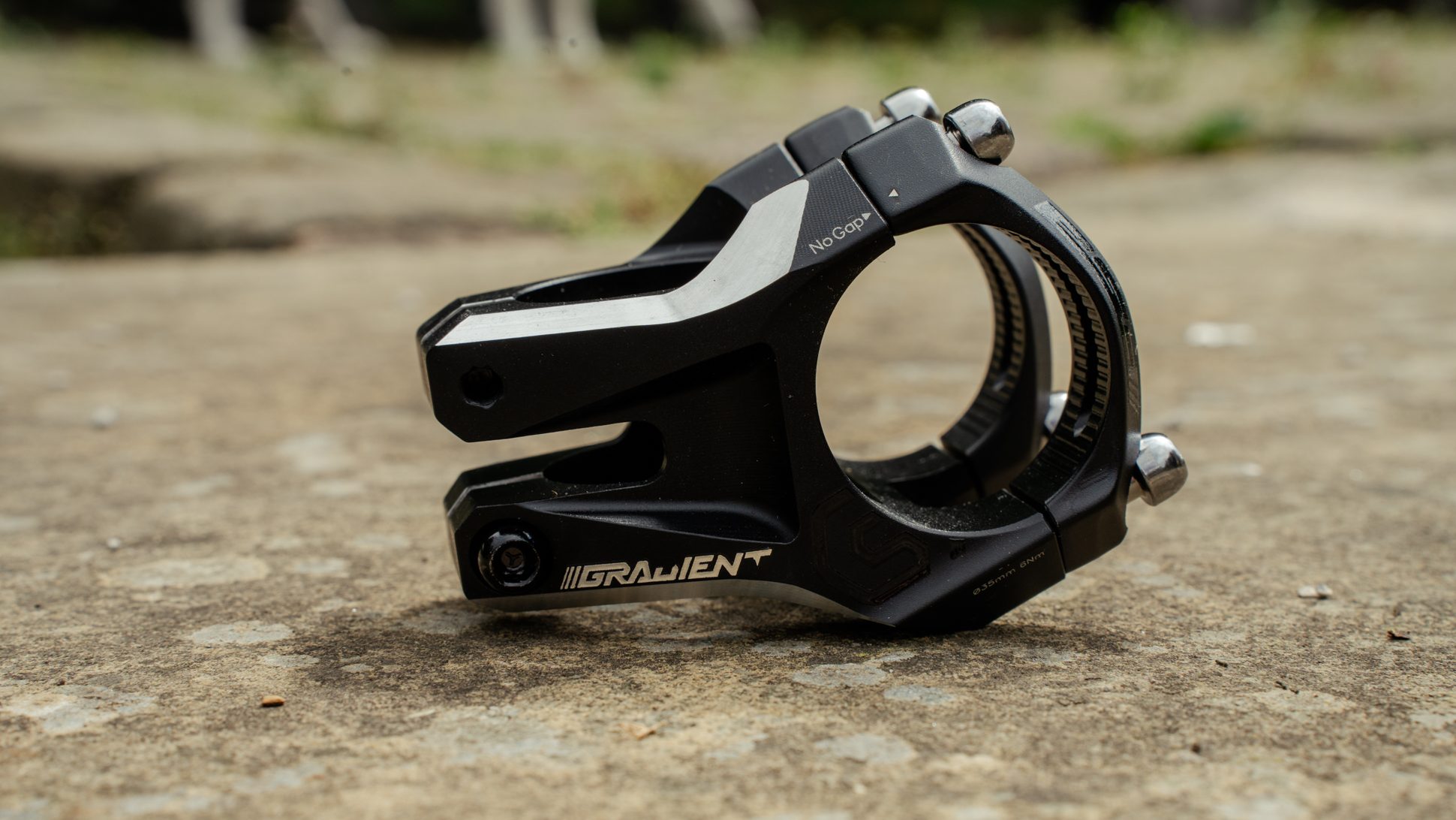 Close-up view of a black Gradient stem with a no-gap design, resting on a textured surface.