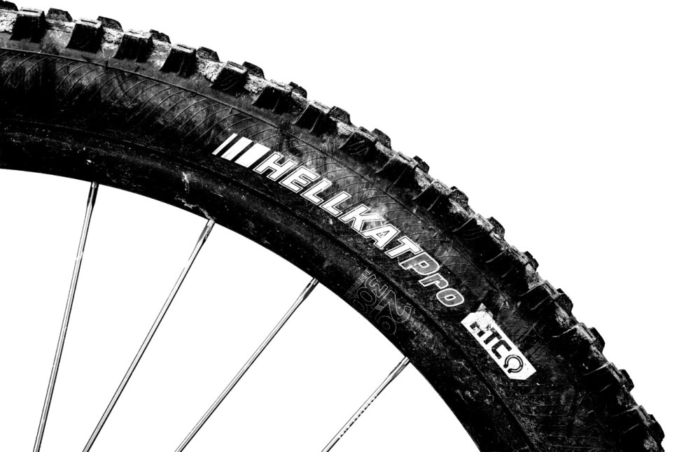 Close-up of a Kenda Hellkat Pro mountain bike tire, showcasing its tread pattern and branding.