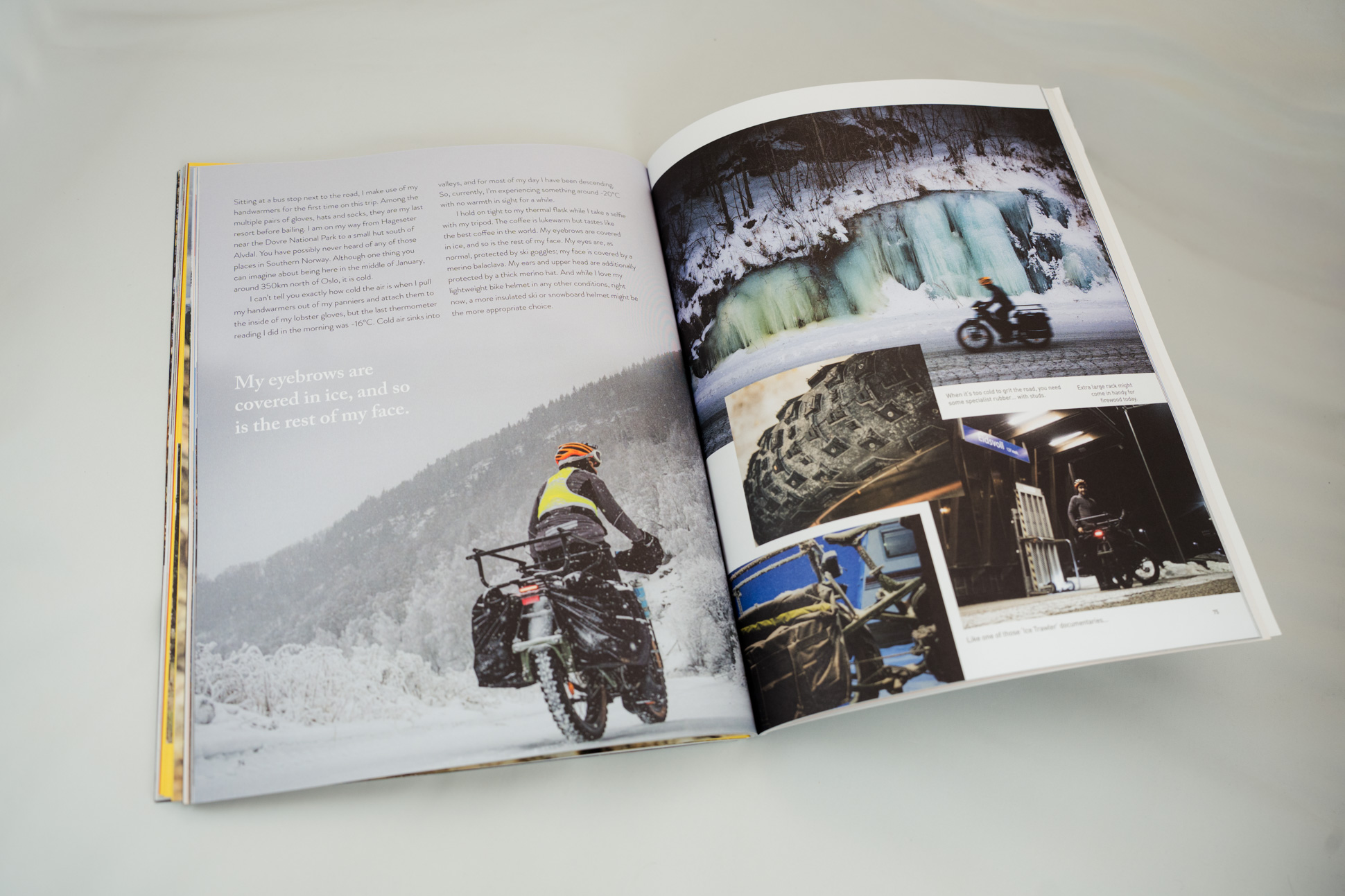 A partially open magazine page displaying text about winter biking, accompanied by various images of snowy landscapes and biking details, including a rider in winter gear.