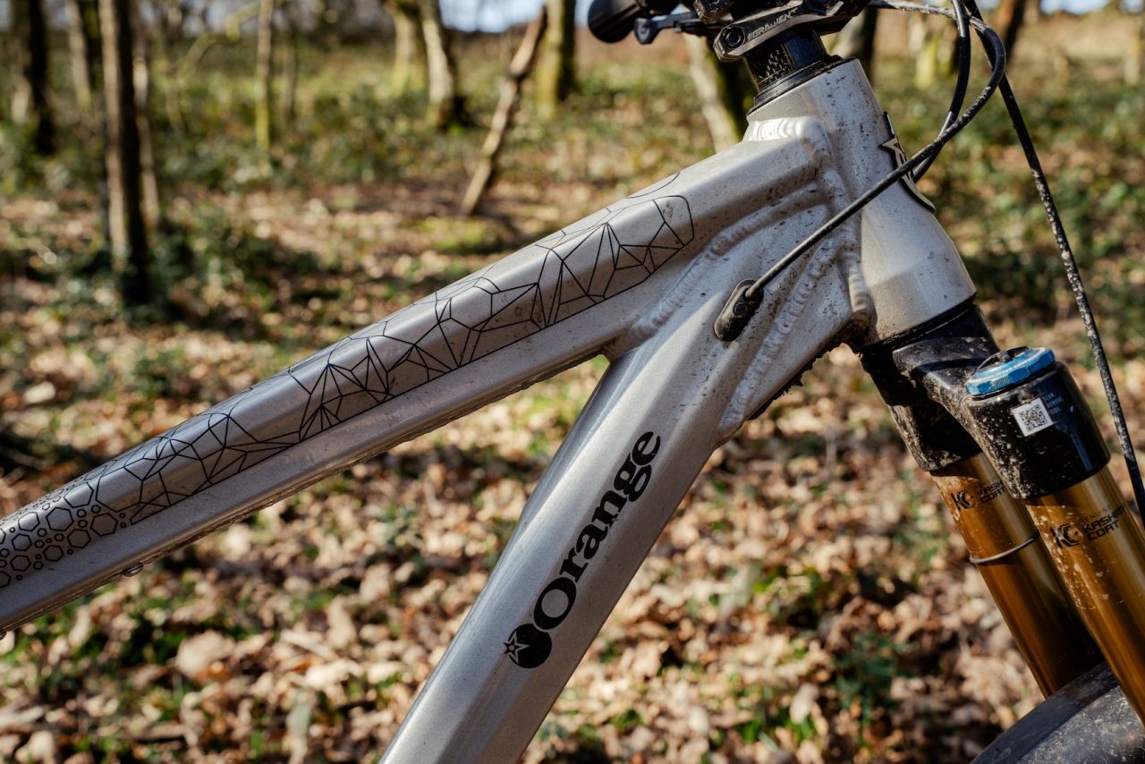 Orange Stage 6 drivetrain and rear suspension close up