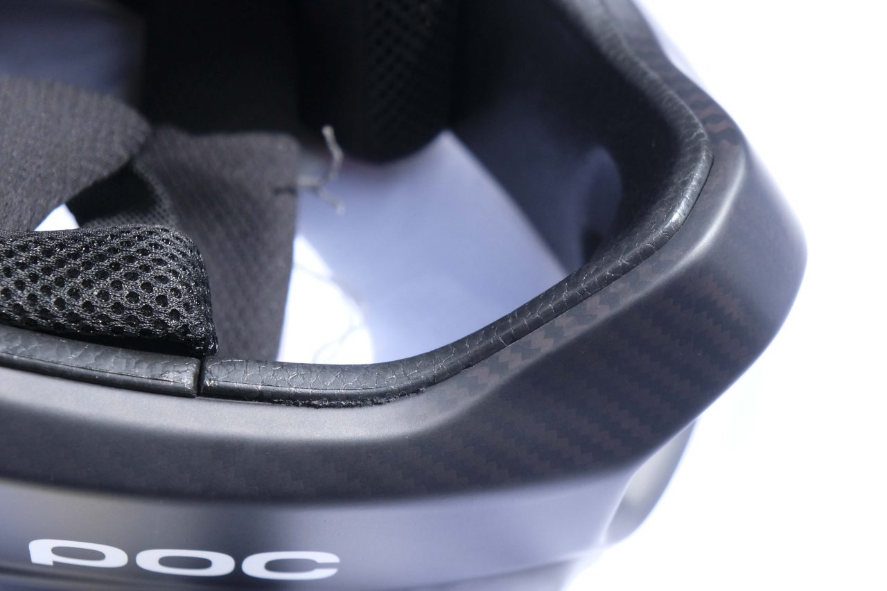 Close-up view of the interior of a POC helmet, highlighting the textured padding and carbon finish.