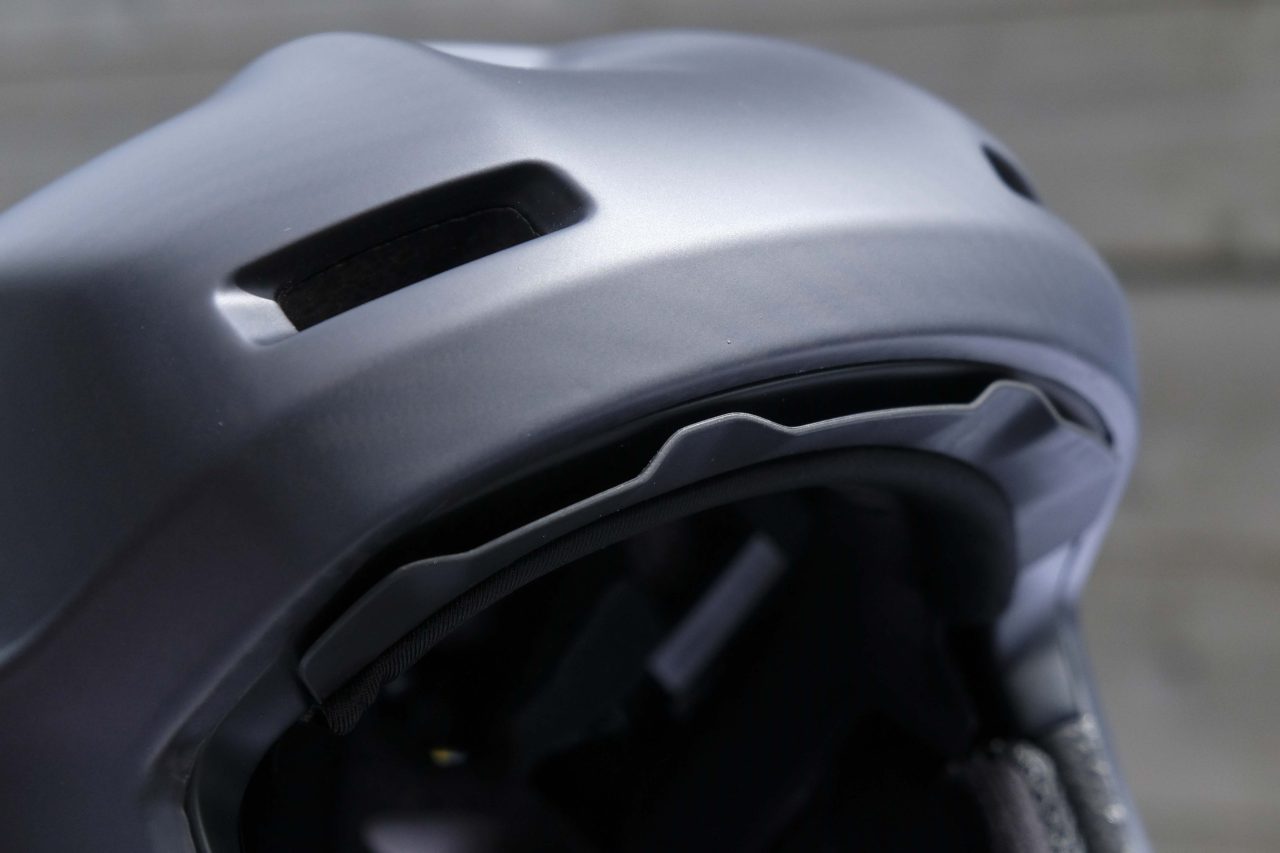Close-up of a black helmet showing ventilation holes and internal padding.