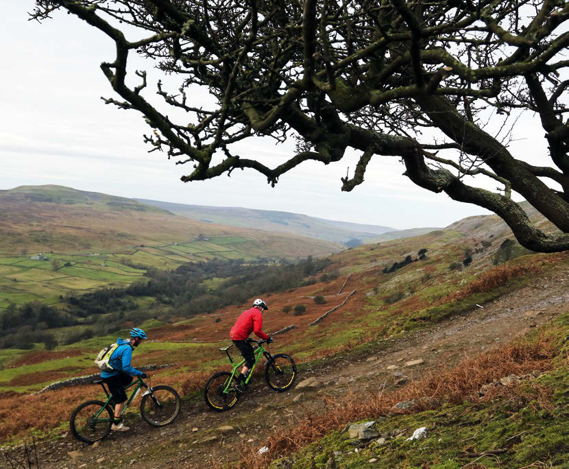 A rider grinds up the steep, rocky Fremington Edge climb above Swaledale in the Yorkshire Dales