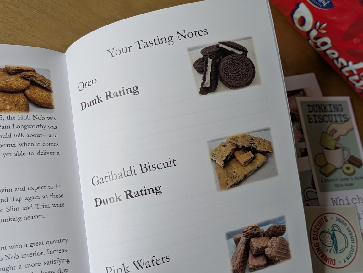 Open book page titled 'Your Tasting Notes' featuring images of Oreo and Garibaldi biscuits, with blank sections for 'Dunk Rating'.