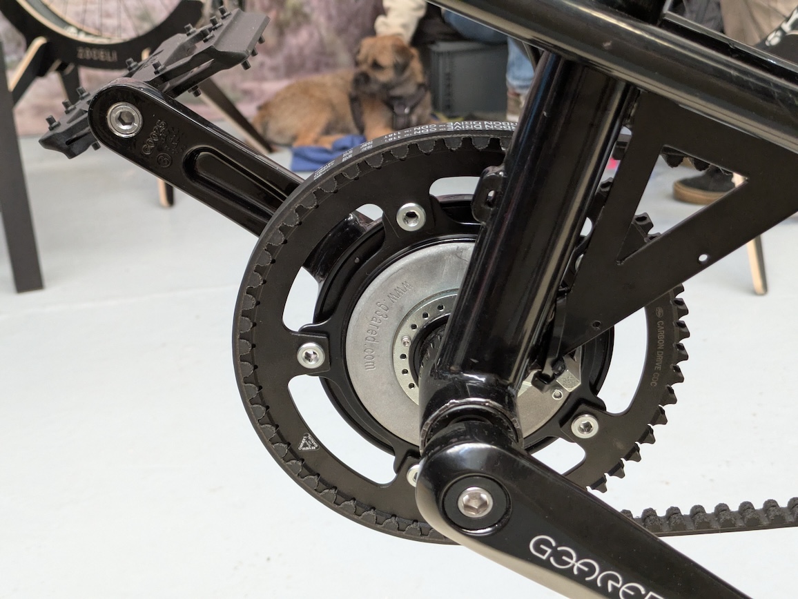 Close-up of a bicycle crankset and chainring, showcasing the intricate gear mechanism and a black finish.
